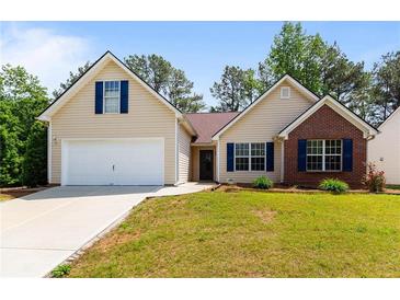 Charming single-Gathering home showcasing a well-manicured lawn, attached garage, and inviting curb appeal at 6416 Chestnut Glen Dr, Norcross, GA 30071