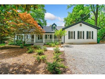 Charming home featuring white siding, black shutters, and a welcoming front porch at 1492 Frazier Rd, Decatur, GA 30033