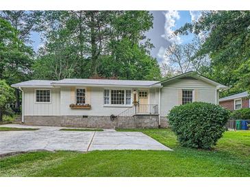 Charming single-story home with stone foundation and meticulously manicured lawn at 2685 Harrington Dr, Decatur, GA 30033