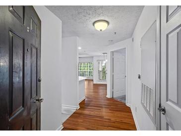 Inviting foyer with hardwood floors leads to a bright living space filled with natural light at 1250 Parkwood Se Cir # 3101, Atlanta, GA 30339