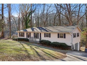 Charming single-story home with vinyl siding, black shutters, and a well-maintained front yard at 409 Katherine Ln, Woodstock, GA 30189