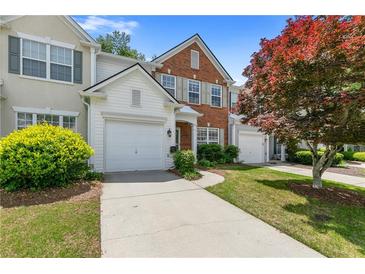 Charming townhome featuring a red brick accent, a single-car garage, and well-maintained landscaping at 3303 Timbercreek Cir, Roswell, GA 30076