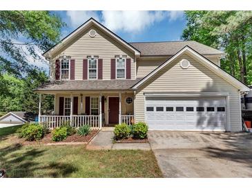 Charming two-story home with a welcoming front porch and manicured lawn at 745 Beaver Pond Trl, Fairburn, GA 30213