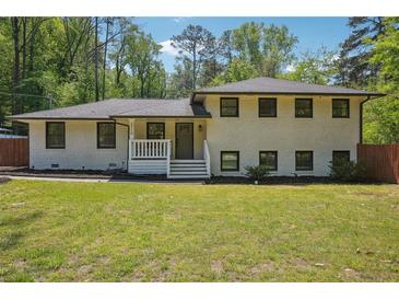 Charming renovated single-Gathering home featuring a freshly painted exterior and lush front lawn at 2710 Hayden Dr, East Point, GA 30344
