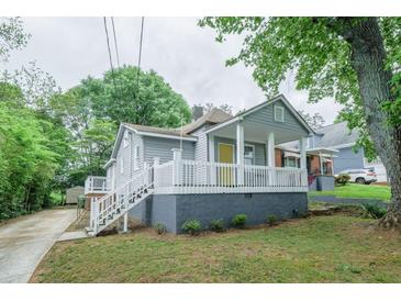 Charming bungalow with a large front porch, gray siding, and a well-maintained lawn and garden at 75 Meldon Se Ave, Atlanta, GA 30315