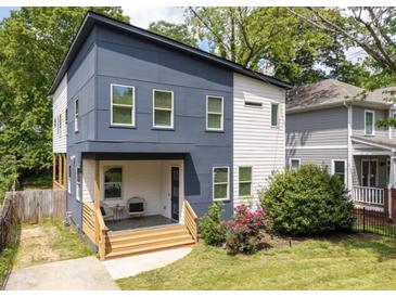 Charming two-story home with a modern design, landscaping, and a welcoming front porch at 210 Locust Ne St, Atlanta, GA 30317