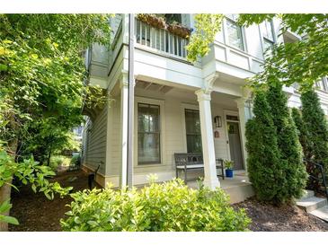 Charming two-story home with a cozy front porch and well-manicured landscaping in a suburban neighborhood at 986 Mauldin Se St, Atlanta, GA 30316