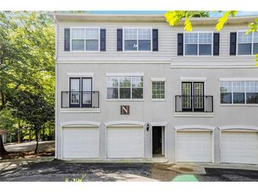 Charming townhome with a three-car garage and classic architectural details at 1150 Collier Nw Rd # 1N, Atlanta, GA 30318