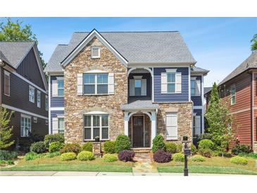 Charming two-story home featuring stone accents, blue siding, well-manicured landscaping and a welcoming entryway at 425 Hunt Ne St, Marietta, GA 30060