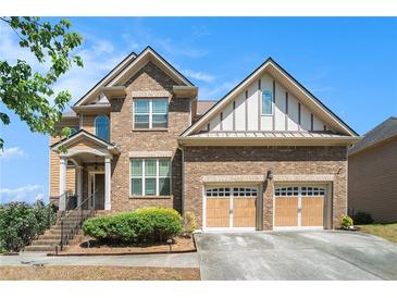 Beautiful two-story brick home with a two-car garage and well-manicured landscaping at 1057 Cotton Oak Dr, Lawrenceville, GA 30045