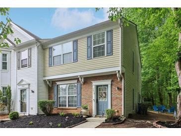 Charming townhouse with brick accents, blue shutters, and landscaped front yard with walkway at 3618 Berkeley Ct # Iv-A, Duluth, GA 30096