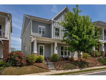 Charming two-story home featuring a landscaped yard, inviting entrance, and classic architectural details at 2467 Davis Se Dr, Smyrna, GA 30080