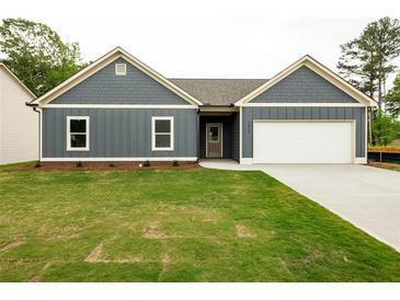 Charming single-Gathering home featuring a well-manicured lawn and a two-car garage at 1810 Forkview Ct, Lawrenceville, GA 30044
