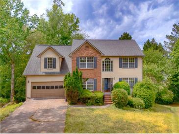 Charming two-story home with a brick facade, well-maintained landscaping, and a two-car garage at 2869 Hickory Run Cir, Duluth, GA 30096