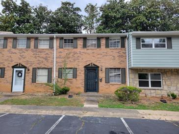 Brick townhouse with dark shutters and a small landscaped area in front at 4701 Flat Shoals Rd # 56D, Union City, GA 30291