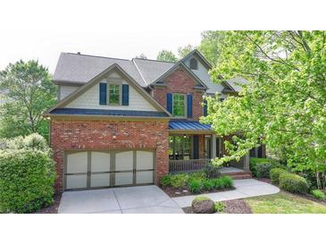 Charming two-story brick home featuring a well-manicured lawn and attached two-car garage at 2725 Monet Dr, Cumming, GA 30041
