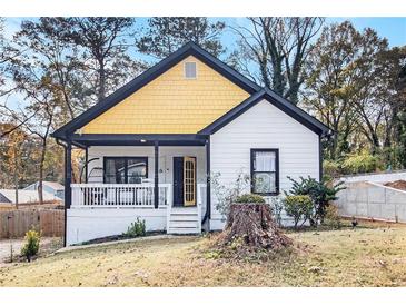 Charming renovated home with a yellow gable, front porch, and fresh landscaping at 1316 Plaza Sw Ave, Atlanta, GA 30310