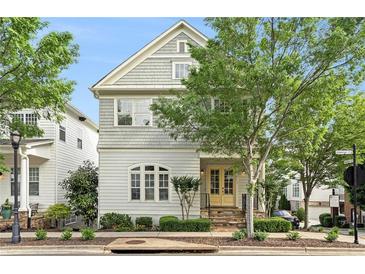 Charming two-story home featuring a gable roof, complemented by a lush, tree-lined street at 169 Waterman Se St, Marietta, GA 30060