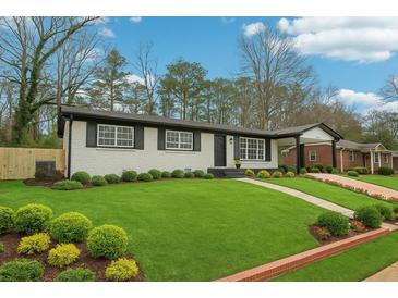 Charming one-story home with a beautifully manicured lawn and mature landscaping at 2401 Winshire Drive, Decatur, GA 30035