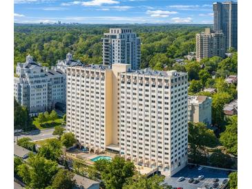 Stunning high-rise building with pool, beautiful landscaping, and scenic views of the surrounding city and lush greenery at 2479 Peachtree Ne St # 1414, Atlanta, GA 30305