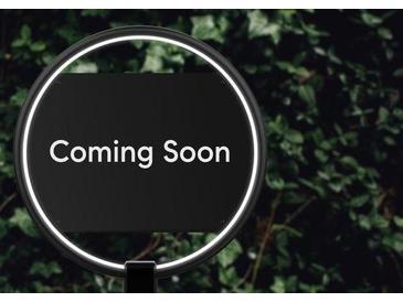 Illuminated 'Coming Soon' sign in front of lush green foliage signals an upcoming real estate opportunity at 4293 Smithsonia Dr, Tucker, GA 30084