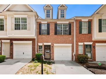 Charming townhome with brick facade, attached garage, and manicured landscaping at 786 Brookside Parc Ln, Avondale Estates, GA 30002