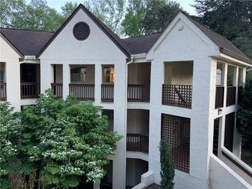 Charming condo exterior with private balconies and lush landscaping at 485 Sherman Way, Decatur, GA 30033
