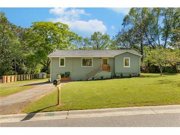 Charming single-story home featuring a well-manicured lawn and inviting curb appeal at 1042 Oakdale Se Dr, Smyrna, GA 30080