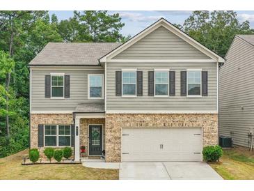 Charming two-story home with a brick and siding exterior and a two car garage at 821 Ethereow Ct, Lawrenceville, GA 30046