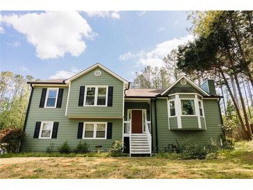 Charming green two-story home with classic white trim and well-maintained front yard at 114 Summer Glen Pl, Dallas, GA 30157