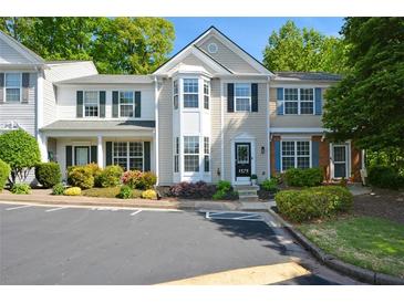 Charming townhome with manicured landscaping, black shutters, and convenient parking at 1575 Kilmington Ct, Alpharetta, GA 30009