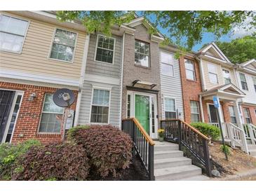 Charming townhome exterior featuring a welcoming front porch and well-maintained landscaping at 2864 Vining Ridge Ter, Decatur, GA 30034