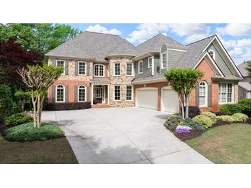 Beautiful two-story home features a manicured front yard, brick and stone facade, and a spacious driveway at 4231 Shamans Dr, Marietta, GA 30062