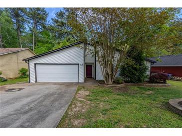 Charming single-Gathering home featuring a well-maintained lawn and a two-car garage at 1287 Peninsula Trce, Lawrenceville, GA 30044