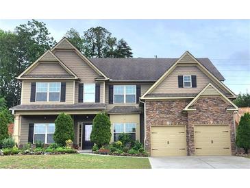 Charming two-story home boasts a stone-accented facade and a well-manicured front yard at 2022 Boxwood Ln, Canton, GA 30114