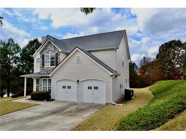 Charming two-story home featuring stone accents and a two-car garage at 5635 Cedar Pass, Fairburn, GA 30213