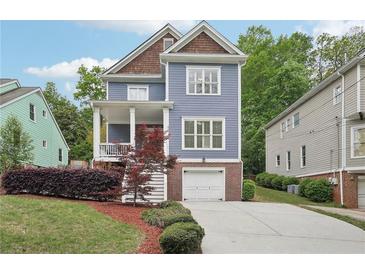Charming two-story home with a well-manicured yard and a blue exterior at 424 Melrose Ave, Decatur, GA 30030