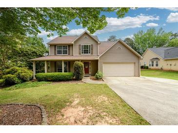Charming two-story home with a covered front porch and well-maintained landscaping, offering great curb appeal at 2055 Springer Walk, Lawrenceville, GA 30043