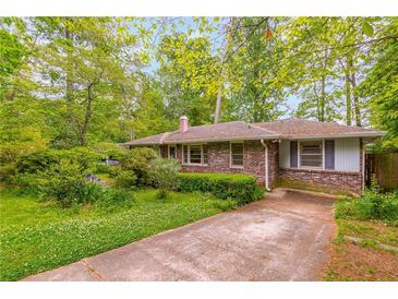 Charming brick ranch-style home with a well-maintained front yard and mature trees at 2783 Mount Olive Dr, Decatur, GA 30033