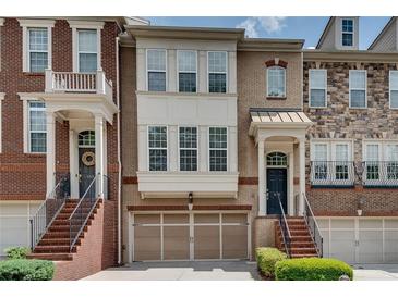 Charming townhome with brick facade, front-entry garage, and inviting entry staircase at 4905 Greylock Se Walk, Atlanta, GA 30339