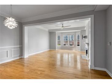 Bright living room features a fireplace, hardwood floors, and large windows at 850 Piedmont Ne Ave # 2509, Atlanta, GA 30308