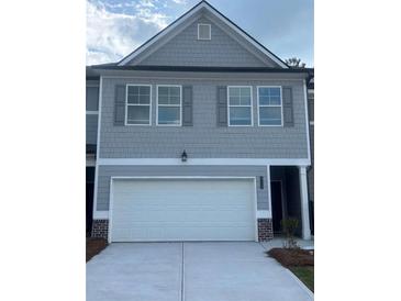 Charming townhome with gray siding, gray shutters, and a two-car garage at 6424 Rosetta Dr, South Fulton, GA 30331