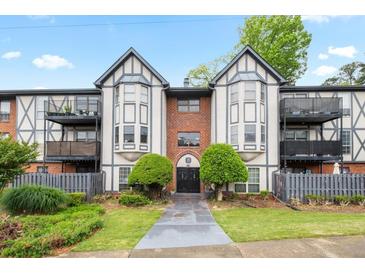 Charming condo exterior with Tudor-style architecture, balconies, and manicured landscaping at 6851 Roswell Rd # B15, Sandy Springs, GA 30328
