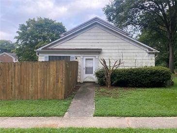 Modest single-story home featuring a small, fenced yard and concrete walkway at 2617 Terrace Pkwy, Morrow, GA 30260