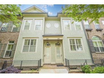 Charming townhome with a light green facade and symmetrical window and door arrangement at 2448 Gatebury Cir, Atlanta, GA 30341