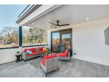 Relaxing outdoor patio with comfortable seating, ceiling fan, and view of surrounding trees at 337 Pine Ne St # B, Atlanta, GA 30308