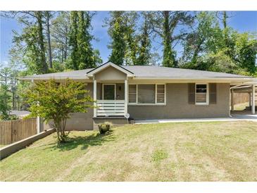 Charming single-story home with a well-maintained front yard, covered porch and a convenient covered carport at 2685 Flagstone Se Dr, Atlanta, GA 30316