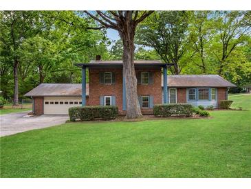 Charming brick two-story home with mature tree and large front yard at 1055 Heather Ct, Lawrenceville, GA 30043