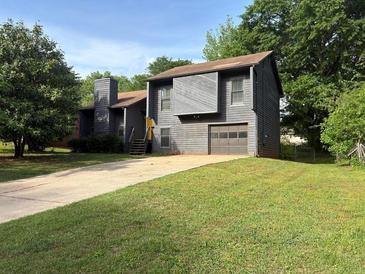 Charming two-story home with attached garage and mature landscaping at 1231 Providence Way, Lawrenceville, GA 30046