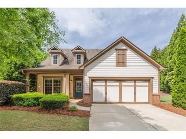 Charming home featuring a two-car garage, manicured lawn, and inviting craftsman architecture at 1355 Hesse Ln, Austell, GA 30106